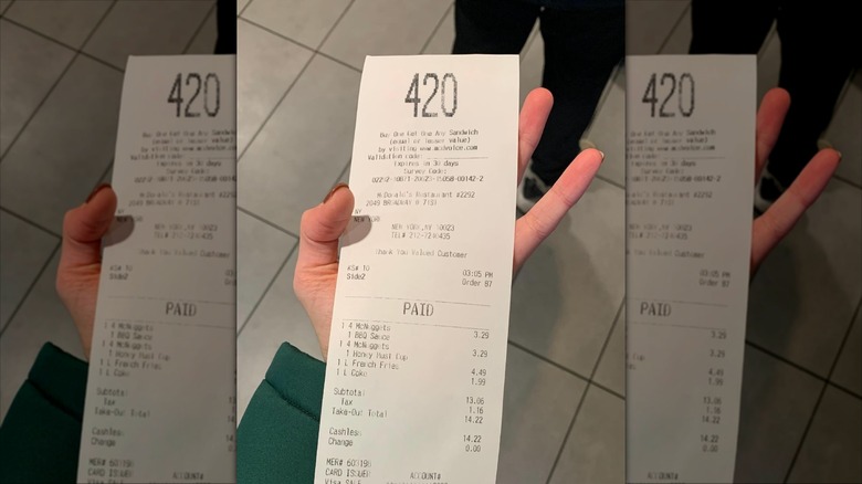 Person holding a McDonald's receipt