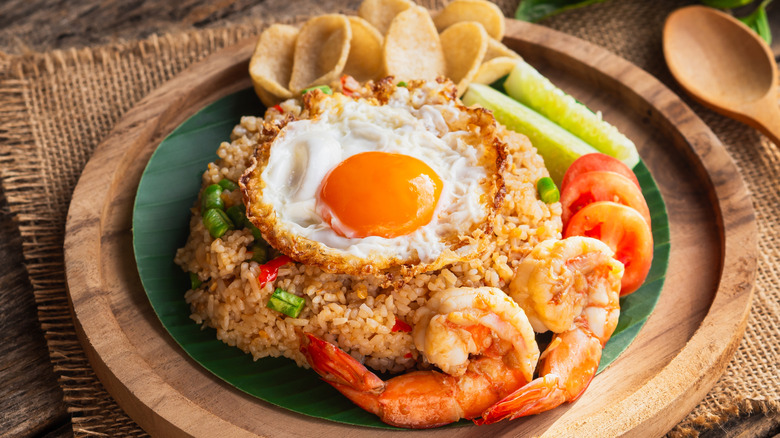 plate of nasi goreng with a fried egg, shrimp, and krupuk