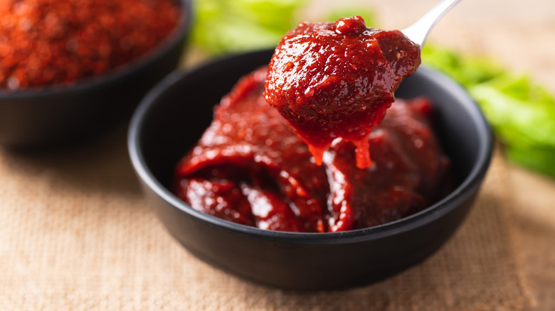 Gochujang sauce in a little bowl and on a tiny spoon