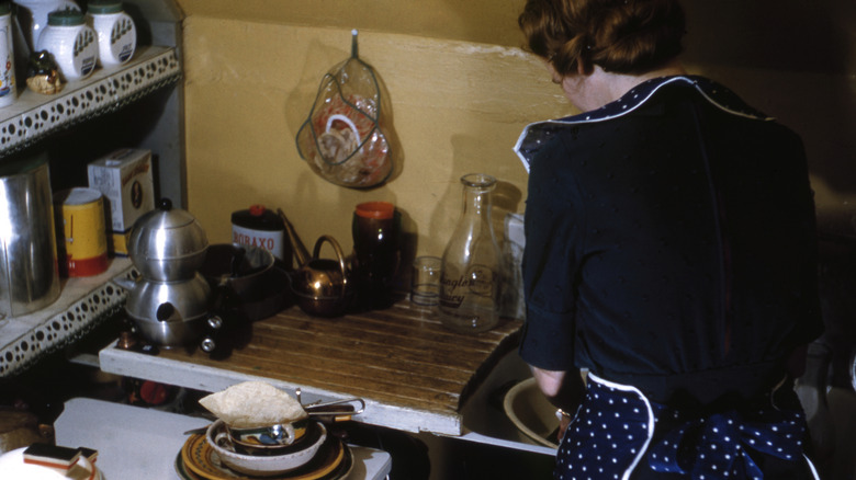 Person in their kitchen in the '40s