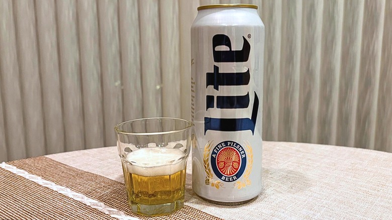 A glass of Miller Lite next to its can