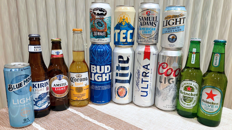 Light beers of many kinds lined up and stacked in a group