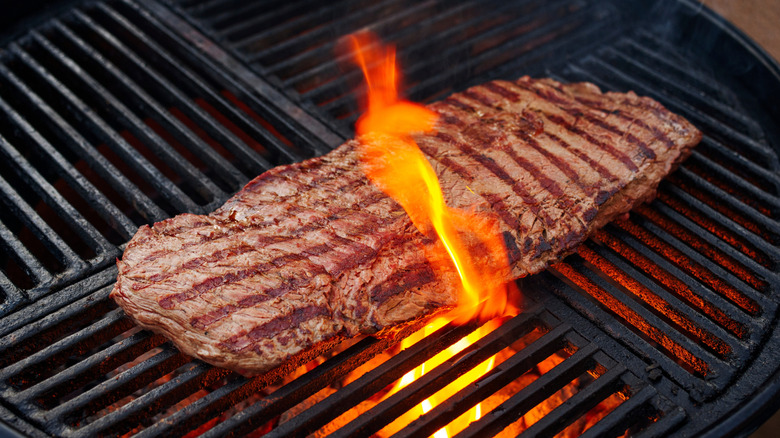 A London broil steak on a grill