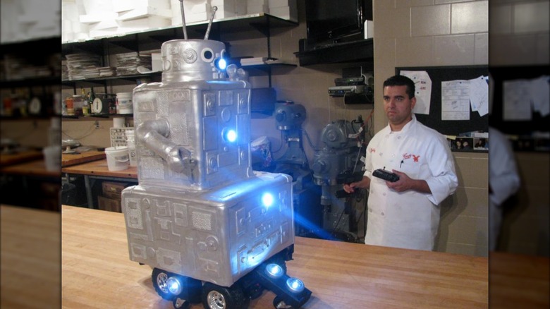 The Cake Boss controlling a robot cake with a remote control