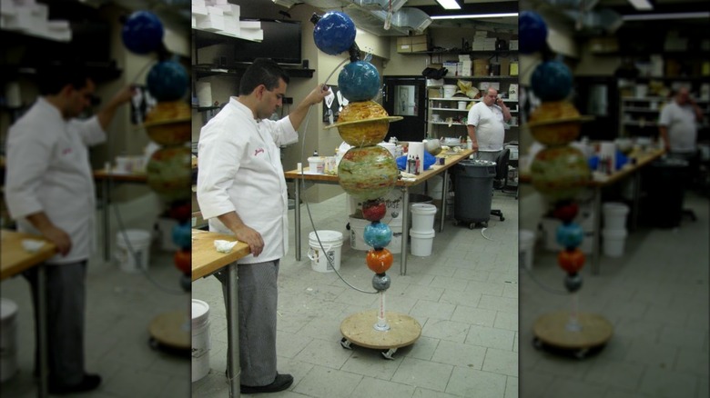 The Cake Boss supporting a planet cake