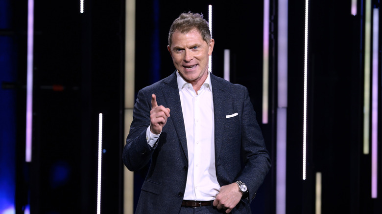 Bobby Flay speaking to a crowd on stage