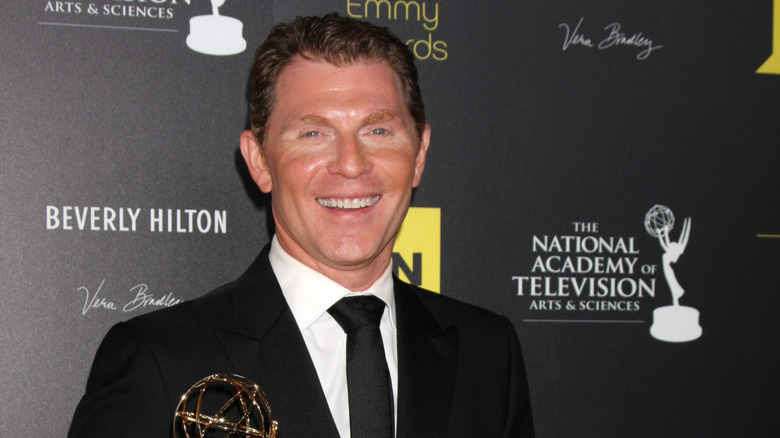 Bobby Flay smiles for the camera at an awards show