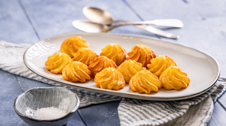 A plate of duchess potatoes on a table