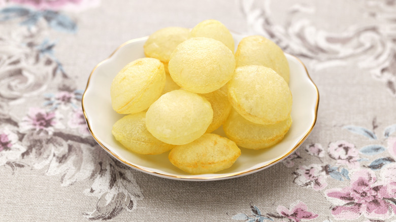 A plate of pommes soufflés on a table