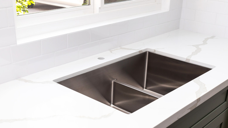 Quartz countertop in kitchen ready for sink faucet installation