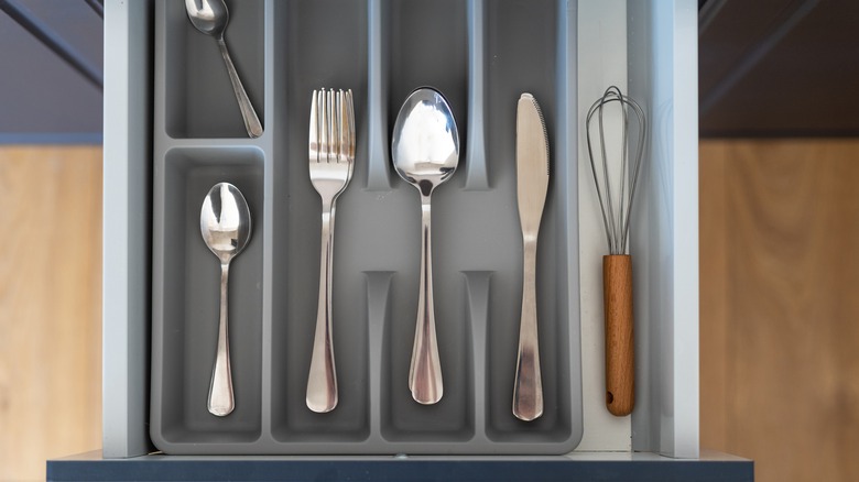Utensils in a dark gray drawer organizer