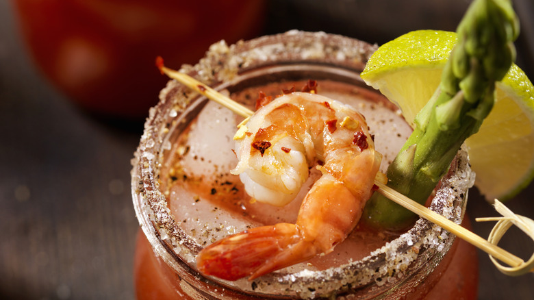 Bloody Mary with salted rim, lime, shrimp, and asparagus