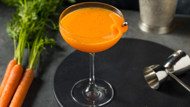 Carrot martini in coupe glass with fresh carrot garnish