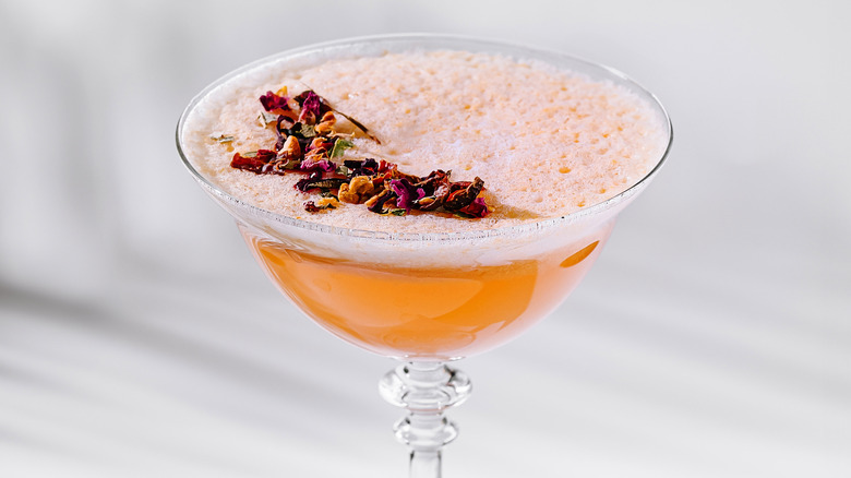 Fruity cocktail with edible flower garnish