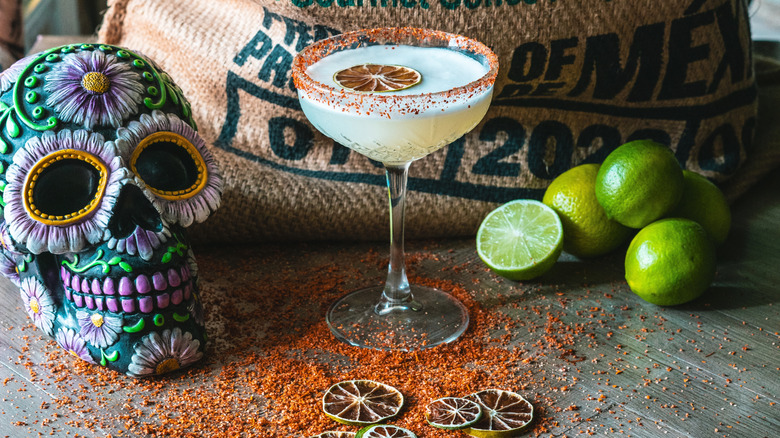 Margarita with Tajín Seasoning rim and limes