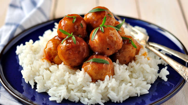 Cider-glazed meatballs on a plate with rice