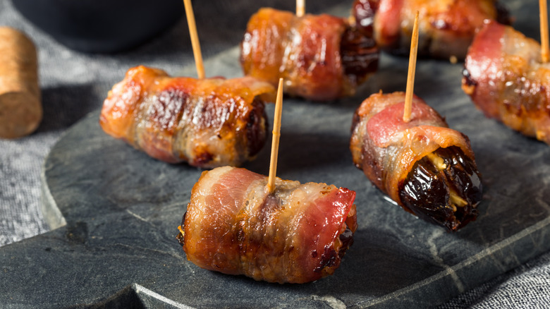 Bacon-wrapped dates on a serving tray