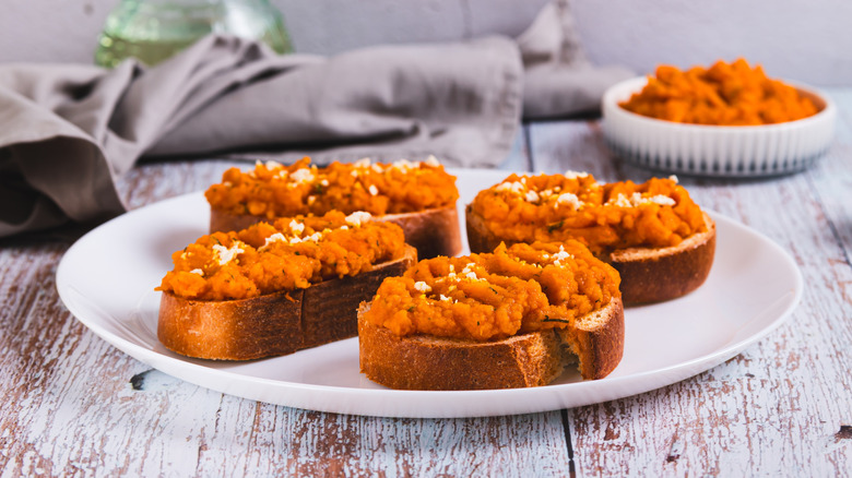 Pumpkin hummus on toast slices