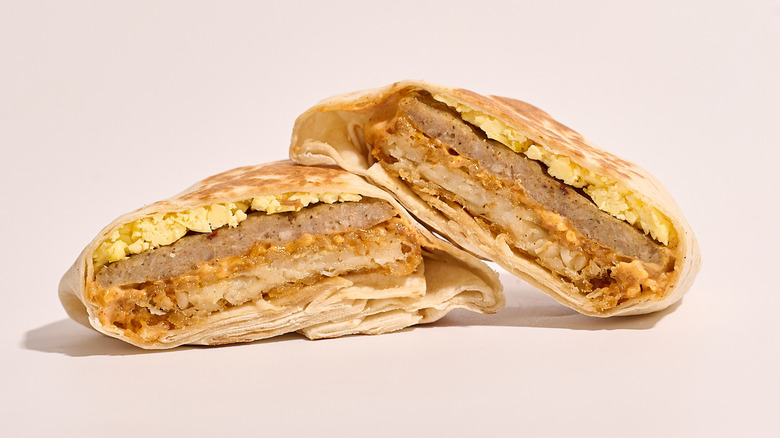 sausage Crunchwrap cut in half on a white table