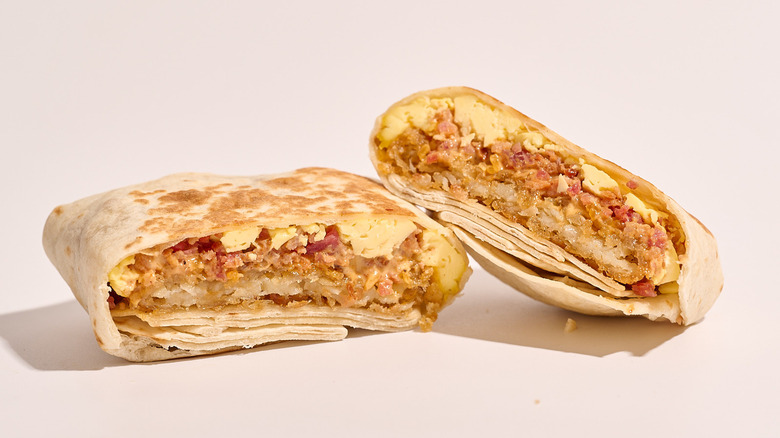 bacon Crunchwrap cut in half on a white table