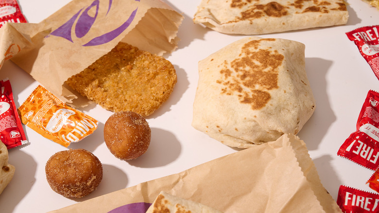 Taco Bell breakfast items spread out on a white table