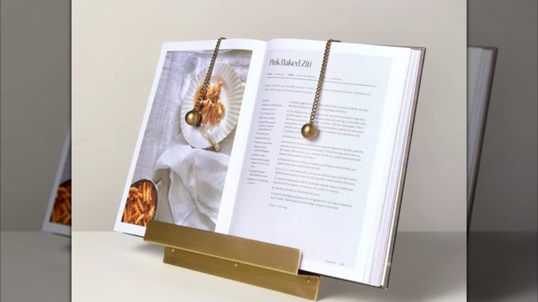 Target's brass cookbook holder with book on display.