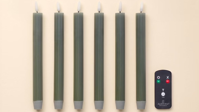six green flameless taper candles with a remote from Target.