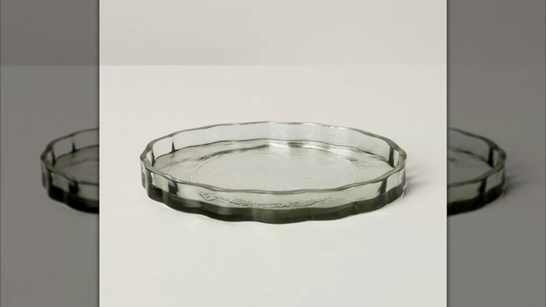 Light green glass soap dish on counter.