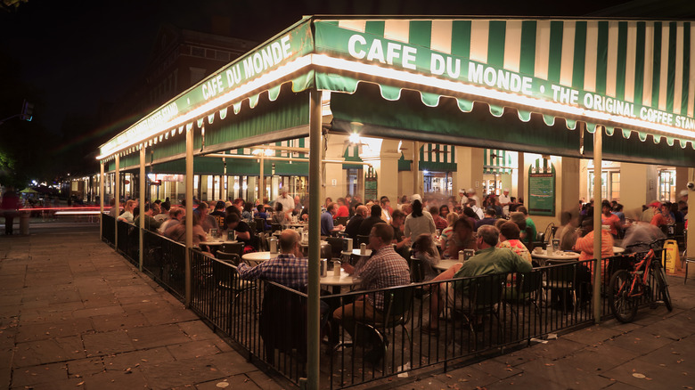 Diners at Cafe du Monde at night