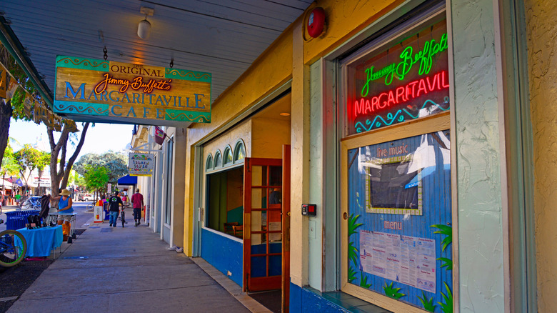 The exterior of Jimmy Buffett's Margaritaville cafe with the restaurant sign hanging