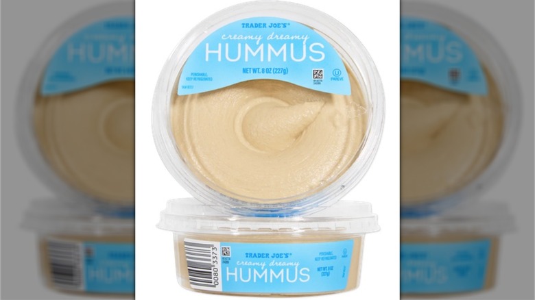 Two containers of Trader Joe's Creamy Dreamy Hummus, with one on top of the second, top label facing the viewer