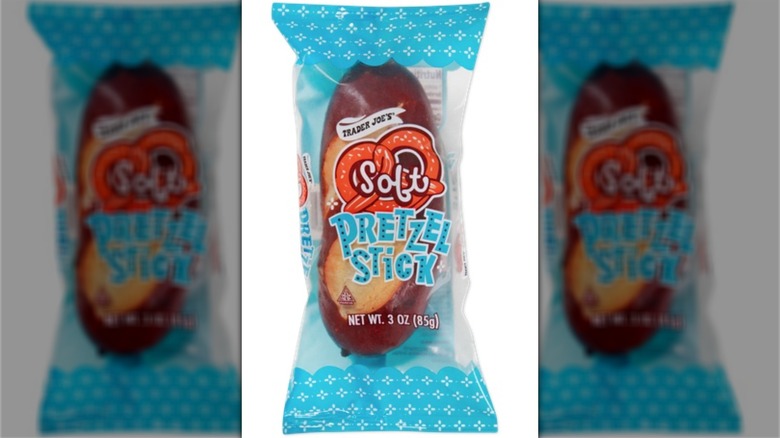 Trader Joe's Soft Pretzel Stick in a wrapper that's clear in the middle except for the logo showing an orange cartoon pretzel, and blue and white on the ends