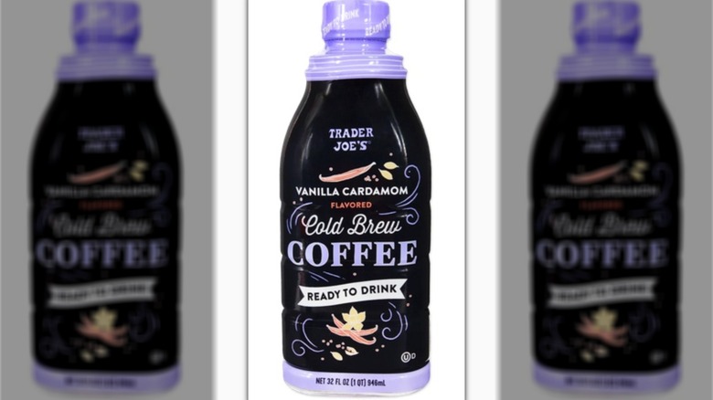 A bottle of Trader Joe's Vanilla Cardamom Cold Brew Coffee, with a black label and lavender safety seal around the cap