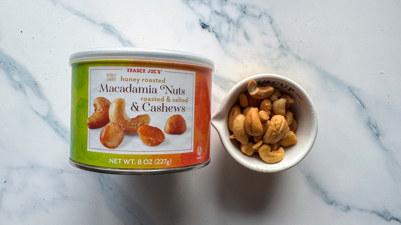 Macadamia nuts and cashews on marble surface