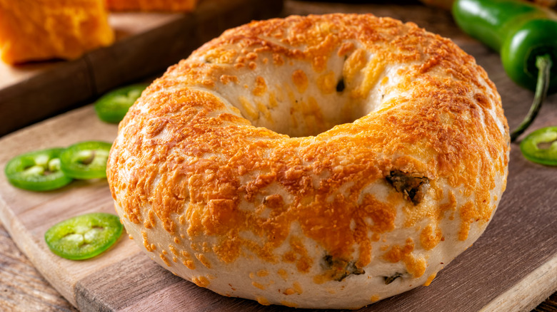 a close-up view of a jalapeño cheddar bagel