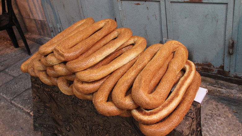 a pile of Jerusalem-style bagels on a street corner