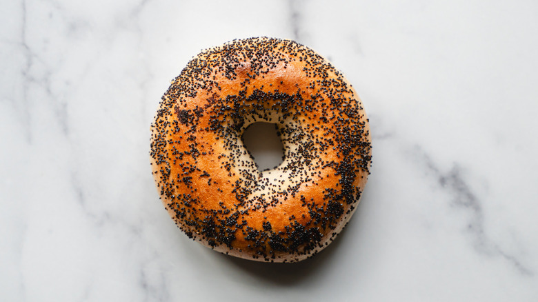 poppy seeds bagel on a marble background