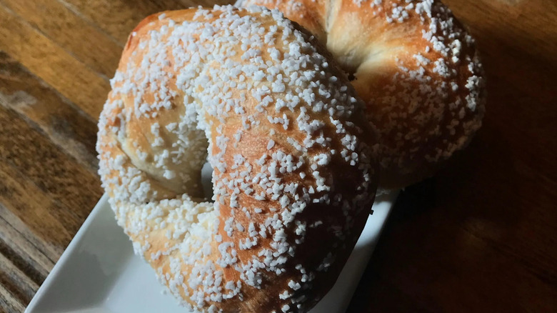 two salt bagels on a white plate