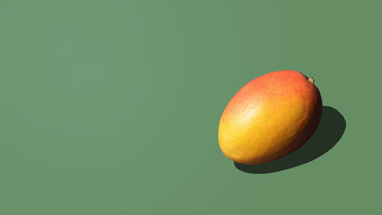 fresh mango on green background