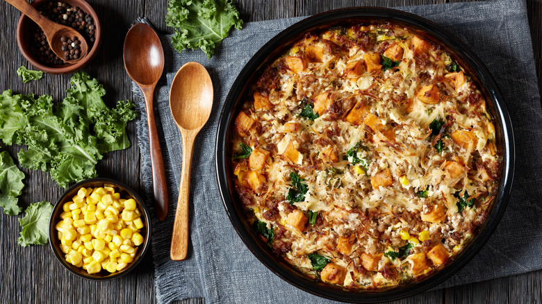 sausage and potato breakfast casserole against a rustic background