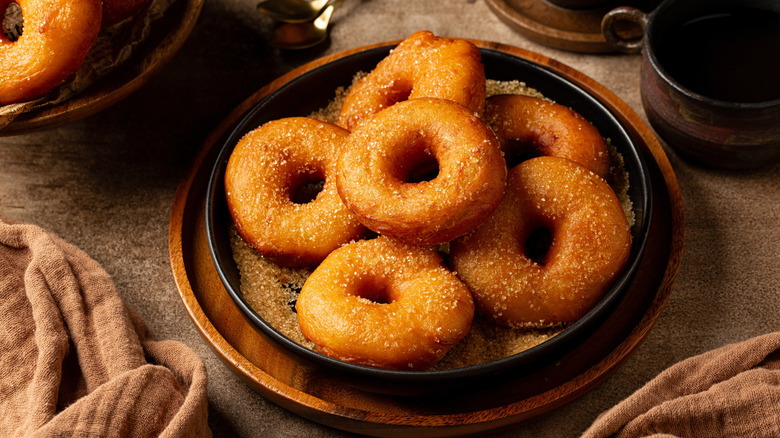 sweet potato donuts dusted with sugar sit in a bowl