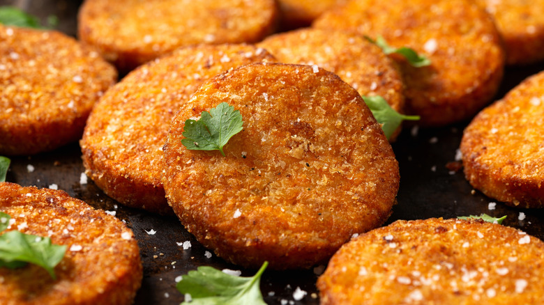 fried sweet potato patties garnished with herbs and salt