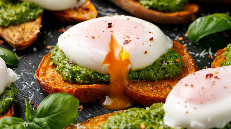 baked sweet potato toast pesto eggs Benedict-style with runny poached egg
