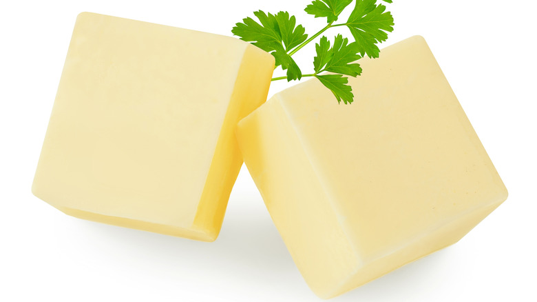 butter cubes and herb on white background