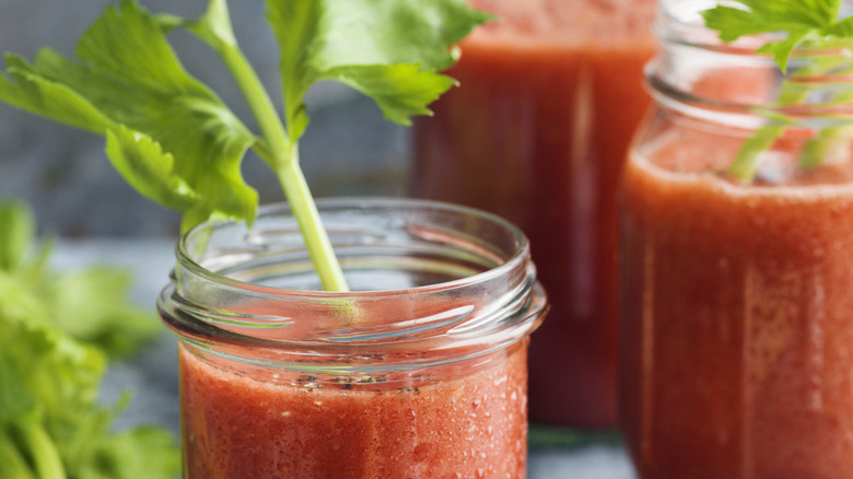 close up of Bloody Mary in mason jar with celery stick