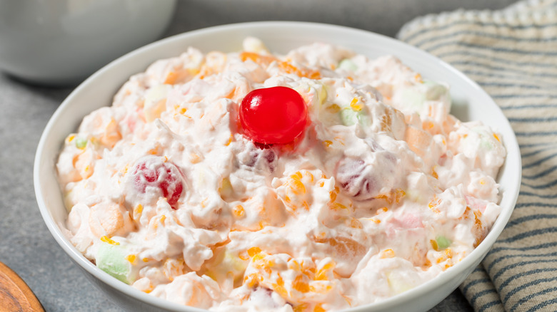 Ambrosia salad in a bowl with a towel
