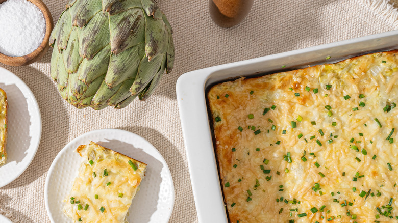 Baked artichoke dip in a white baking tray