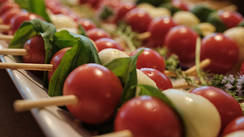 Caprese salad of tomatoes, basil, and mozzarella on cocktail sticks