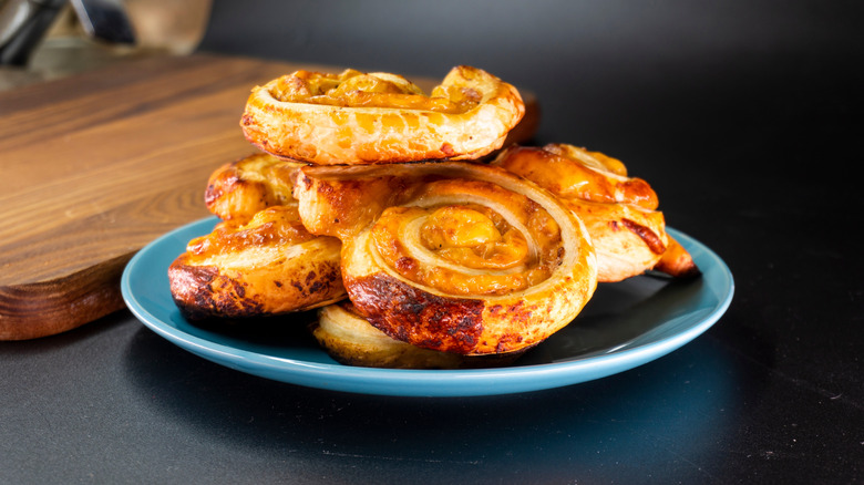 Puff pastry cheese pinwheels served on a blue plate