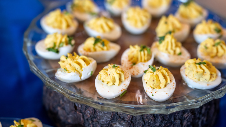 Classic deviled eggs served on a glass tray